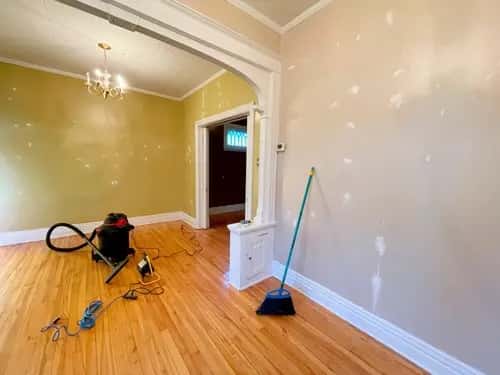 Detail cleaning of baseboards and newly installed trim after renovation